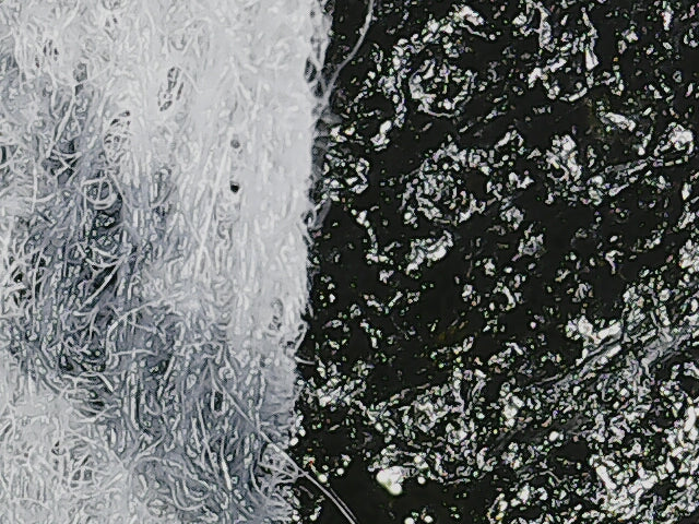 Up close image of cast iron skillet surface with a biodegradable plant based wipe with carbon steel and cast iron seasoning oil