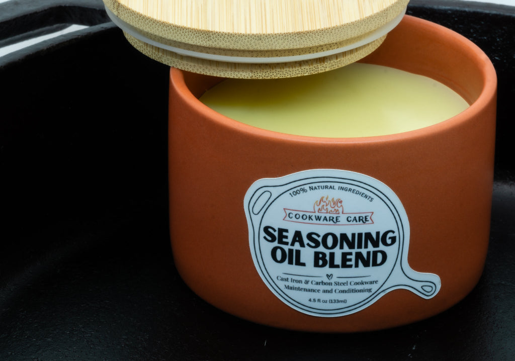 Seasoning Oil Blend with open lid inside a cast iron
